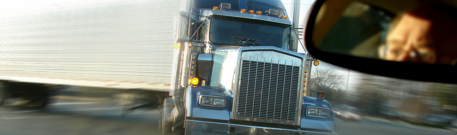View through the windshield as a semi-truck careens toward a driver